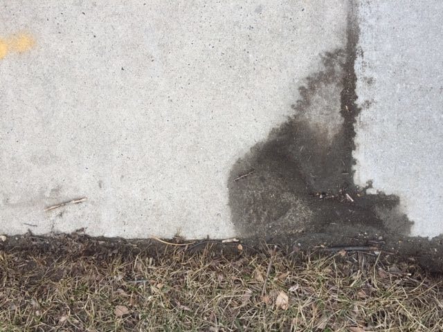 Close-up photo of mud puddling on a sidewalk