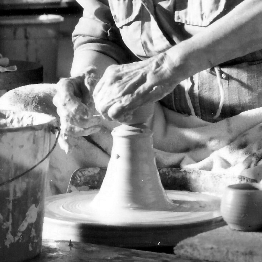 Hands working clay