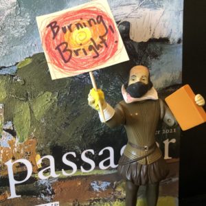 Shakespeare doll holding sign that says "Burning Bright!"
