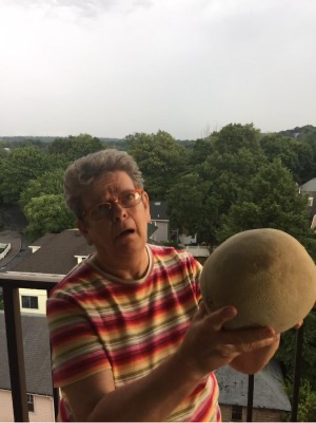 Sue Katz holding a large cantaloupe