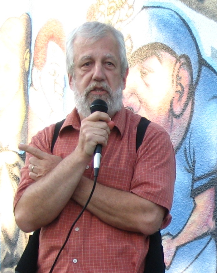 Patrick Hansel speaking at a microphone
