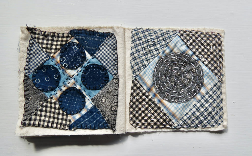 circles of blue patterned fabric on checkered squares sewn together