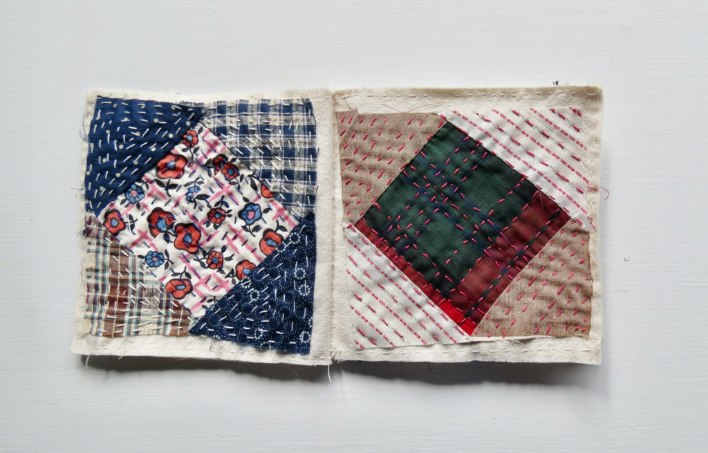 diamonds of different patterned fabric stitched together with colorful crosstitching