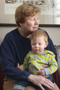 Ginny Lowe Connors holding her grandson, toddler